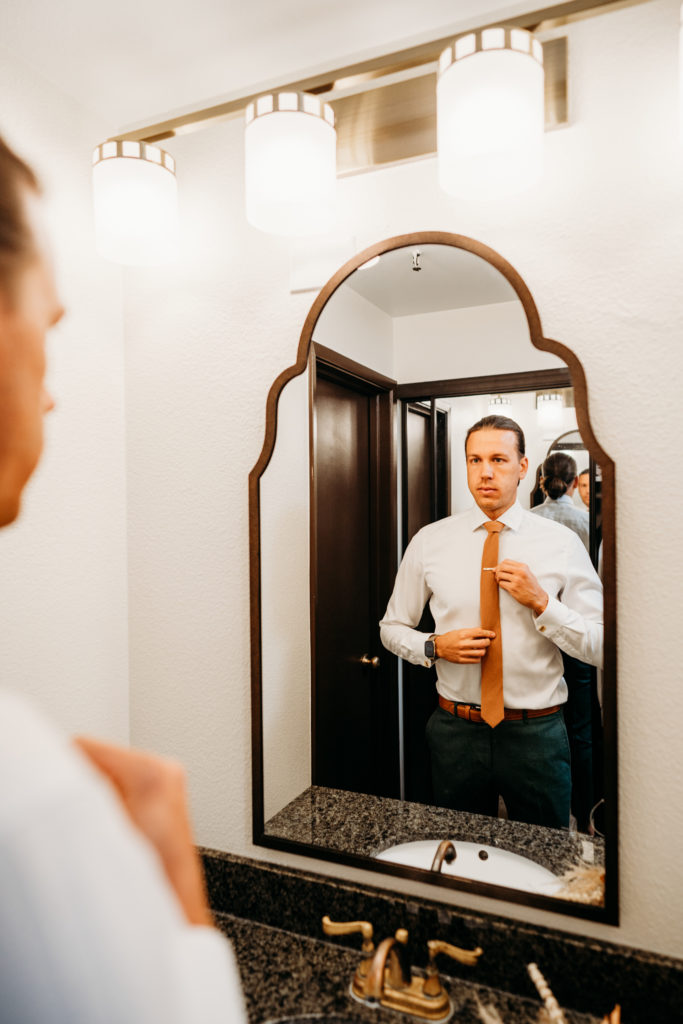Groom getting ready at elopement