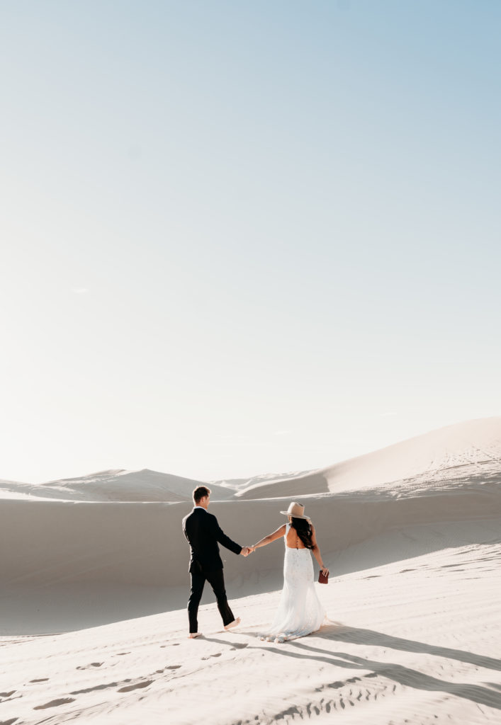 couple holding hands in the desert