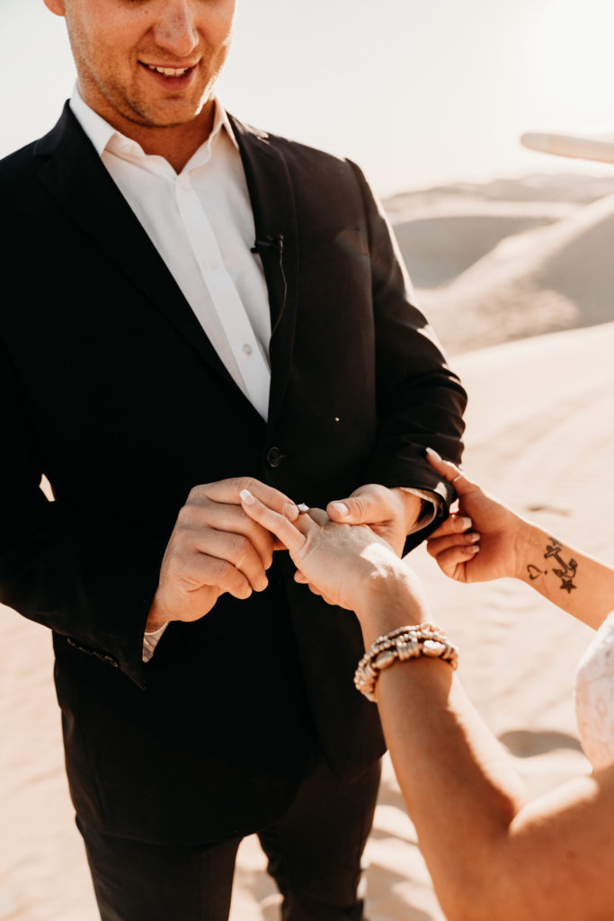 Bride and groom exchanging rings at elopement