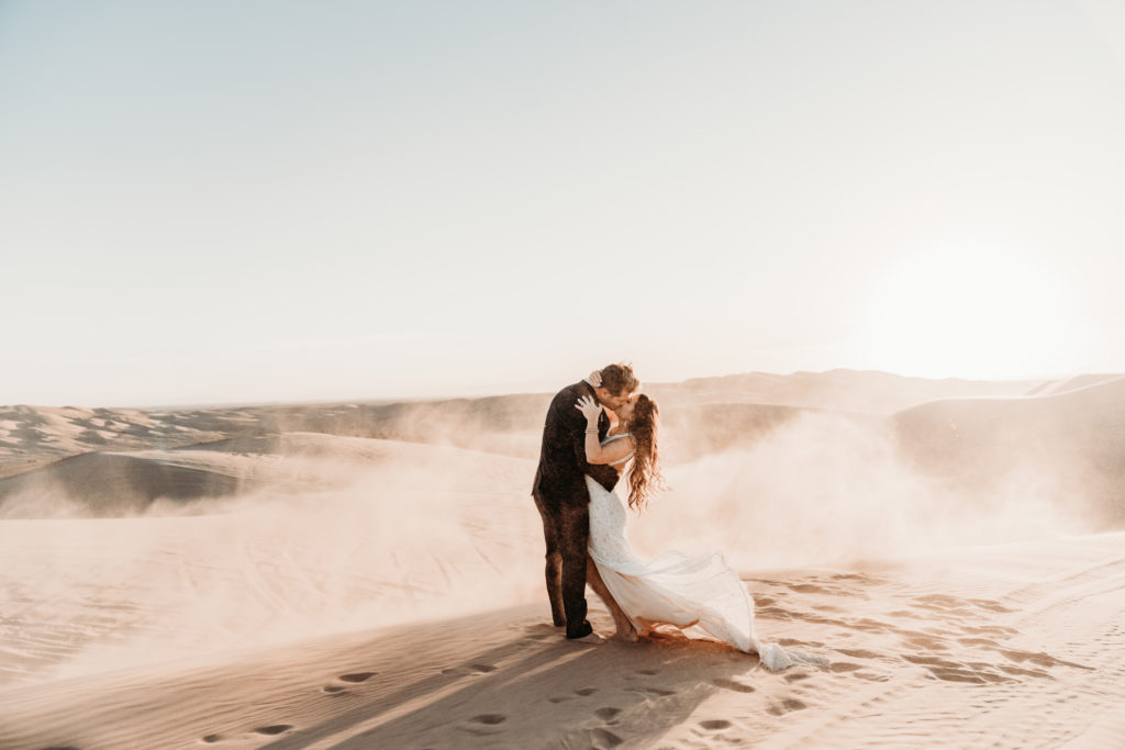 Couple kissing in Sand Dunes.