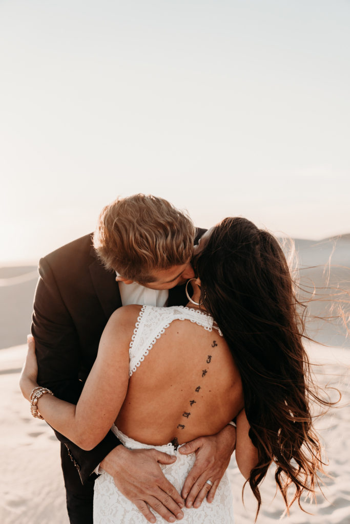 open back wedding dress with groom holding her back