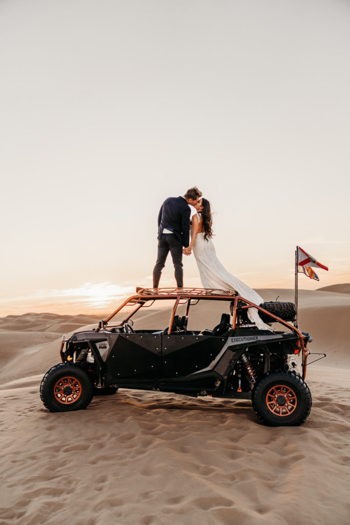 Wedding photo of couple on top of side by side 4x4