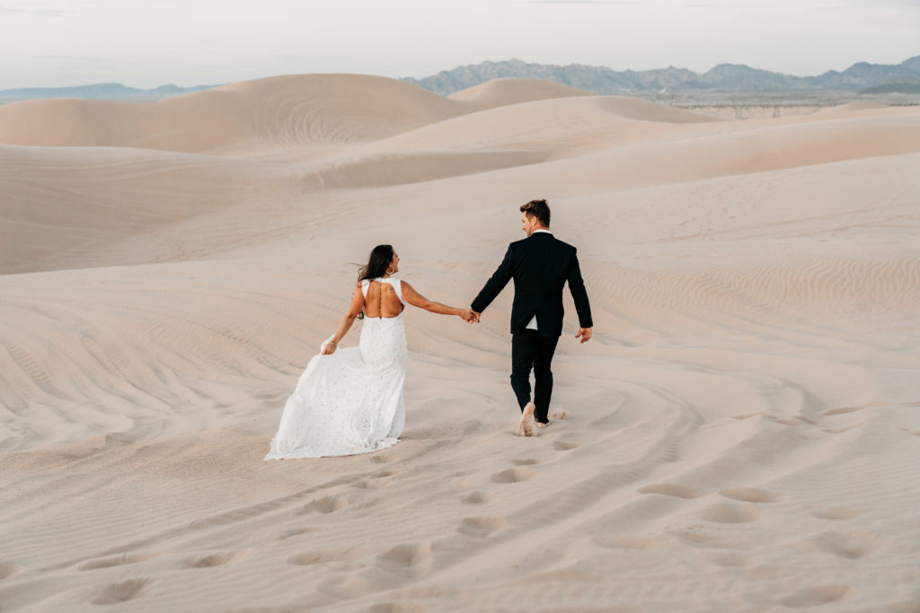 Couple holding hands in Imperial Sand Dunes