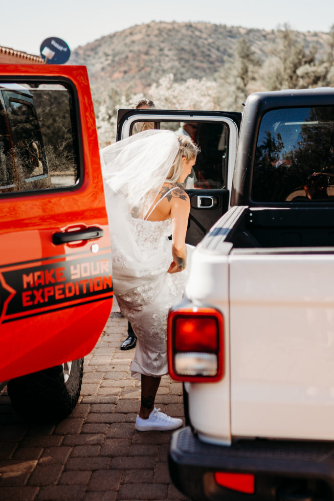 bride getting into Jeep