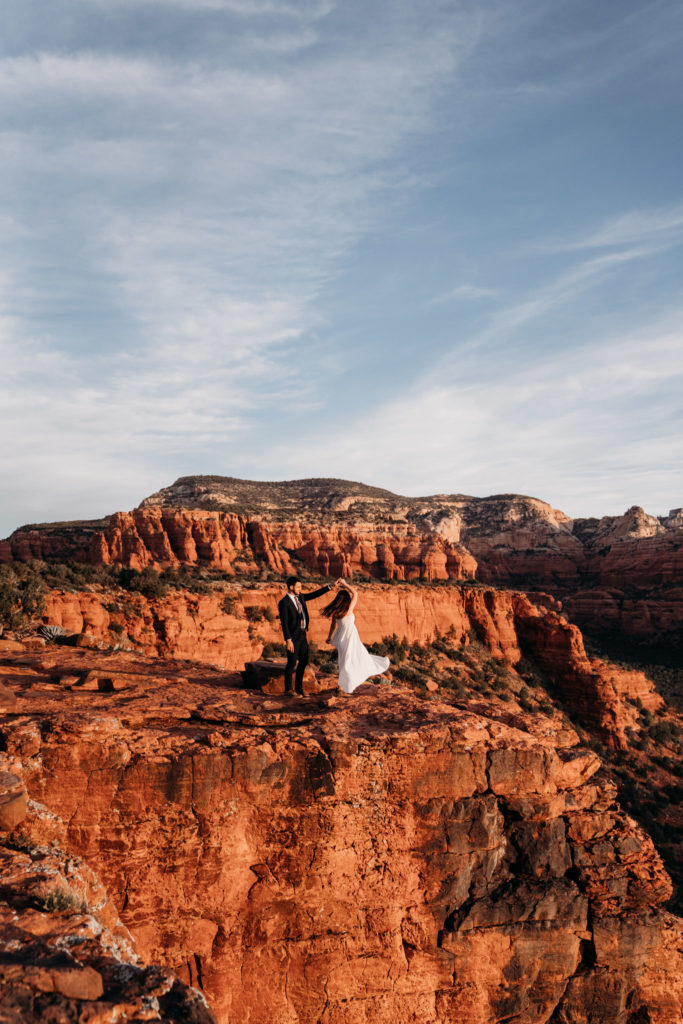 Bride and groom spinning at Sedona elopement.