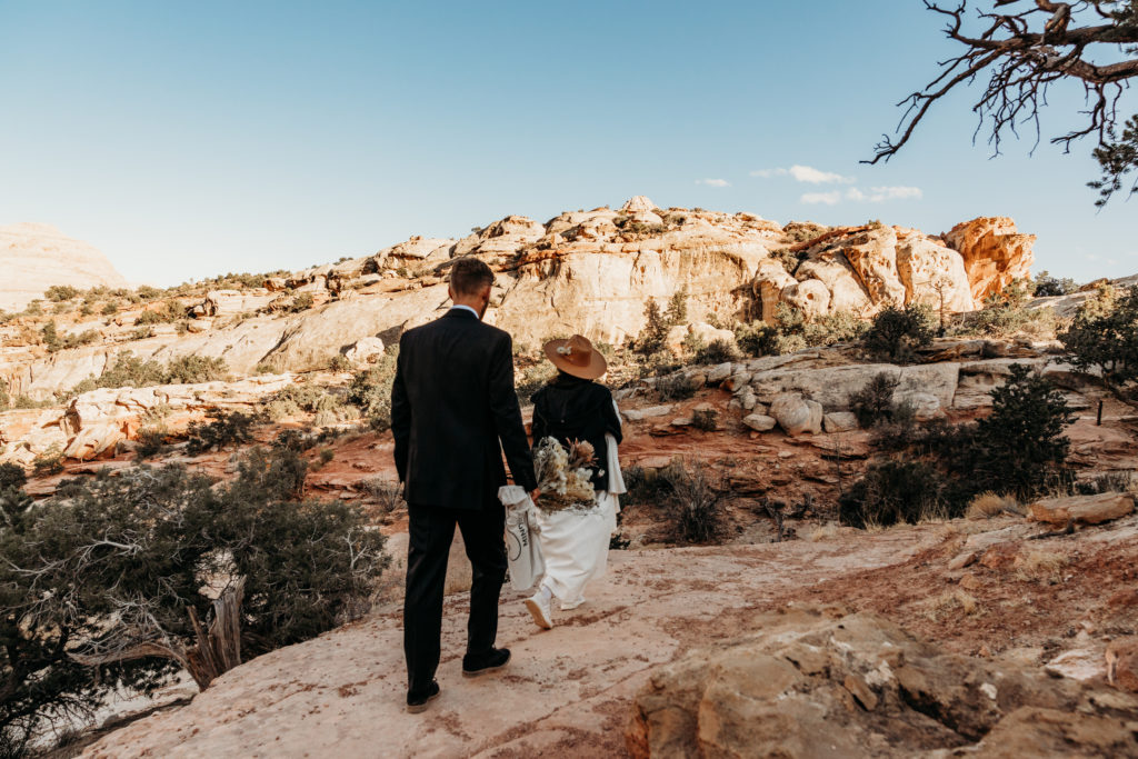 Bride and groom hiking at Capitol Reef elopement
