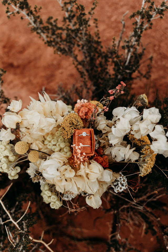 Moab, Utah elopement photo with rings and flowers