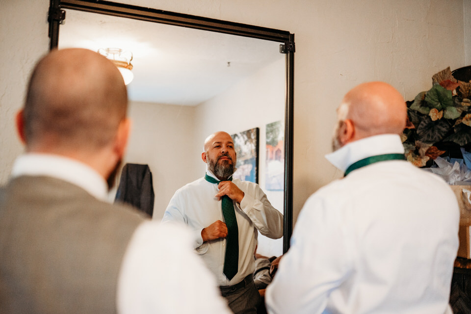 Groom getting ready at Boojum Tree Hidden Gardens
