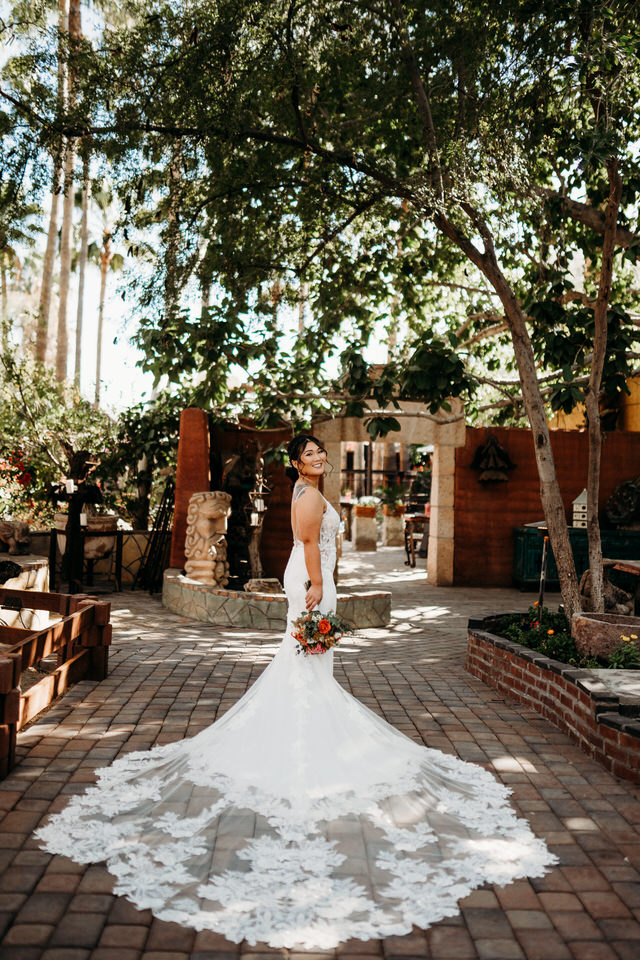 Bride standing in gardens at Boojum tree