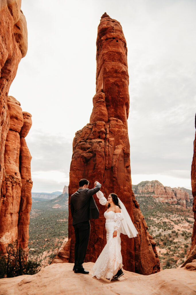 Wedding couple dancing at Cathedral Rock in sedona arizona after eloping