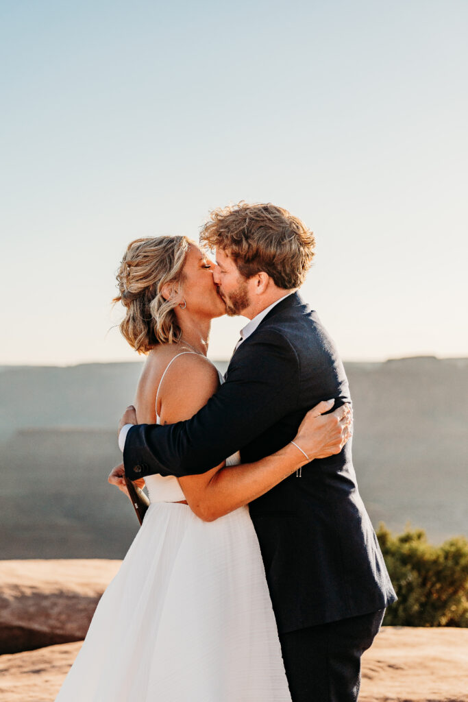 A Deadhorse Point elopement with a relaxed evening timeline, vineyard portraits, and an intimate sunset ceremony overlooking the canyon.