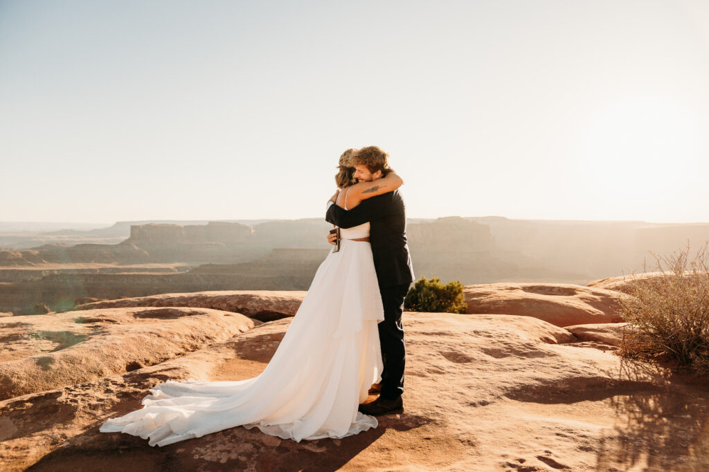 A Deadhorse Point elopement with a relaxed evening timeline, vineyard portraits, and an intimate sunset ceremony overlooking the canyon.