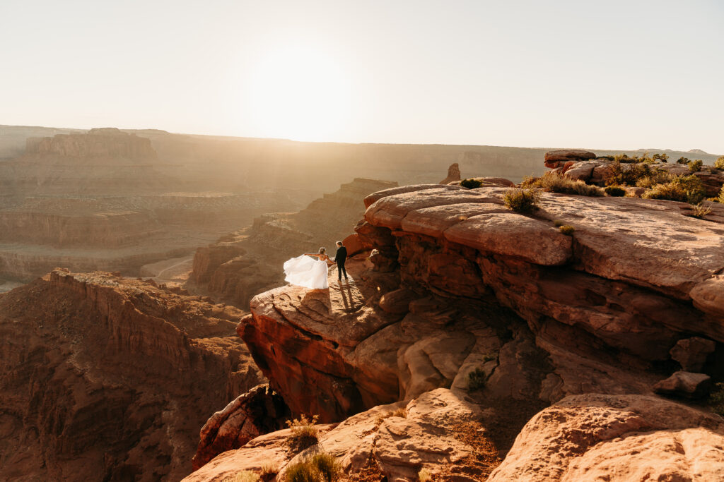 A Deadhorse Point elopement with a relaxed evening timeline, vineyard portraits, and an intimate sunset ceremony overlooking the canyon.