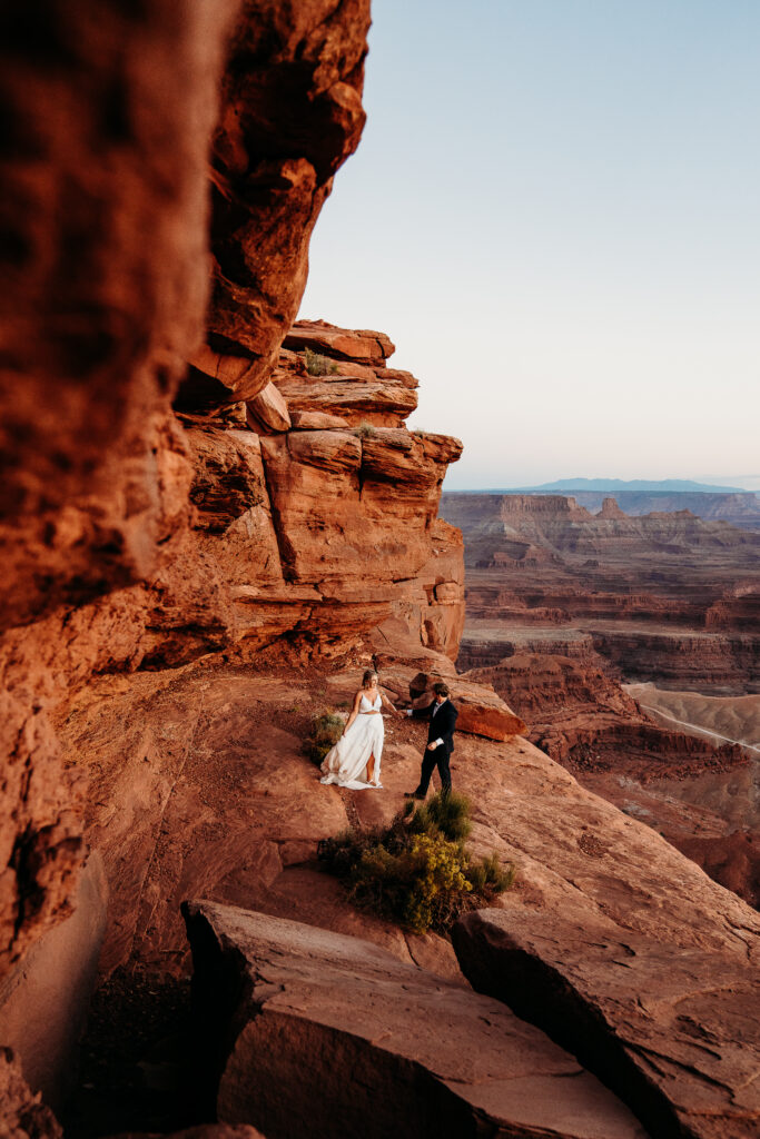 A Deadhorse Point elopement with a relaxed evening timeline, vineyard portraits, and an intimate sunset ceremony overlooking the canyon.